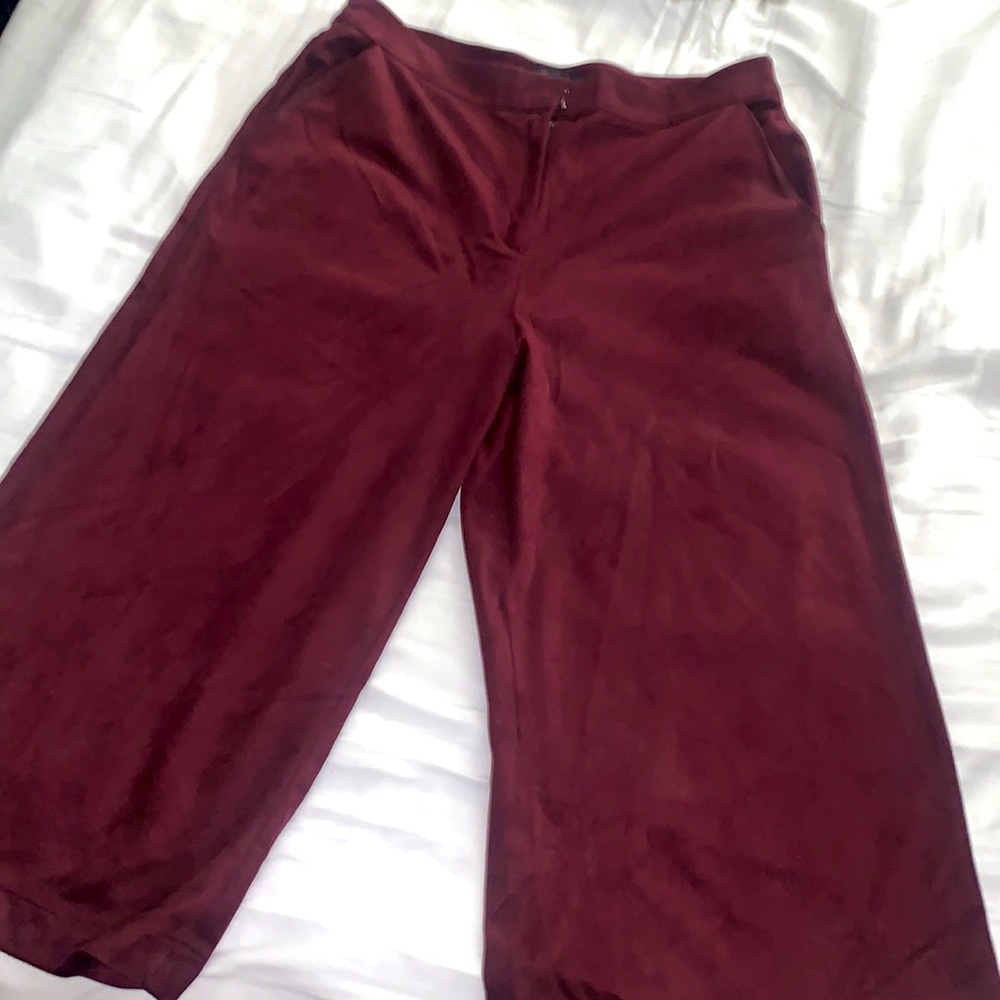 Wide legged, cropped pants in a burgundy suede material.